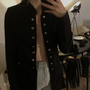 Blazer med knappar - Cool, svart tygjacka/blazer med fina knappar. Väldigt gott skick. Storlek M, men skulle säga S.