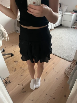 Svart volang kjol - Säljer denna svarta volang kjol. Säljer för har för många kjolar. Väldigt bra skick för har inte använt den så mycket. 