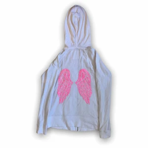 Victoria’s secret kofta med vingar - Söt Victoria’s secret angels zip up hoodie med änglavingar i rosa paljetter på baksidan💗💸  På vänstra fickan sitter det en berlock i form utav änglavingar. Dragkedjan är också ett par vingar 🌷 Lite nopprig, syns inte så mycket. Storlek XS, passar XS/S  