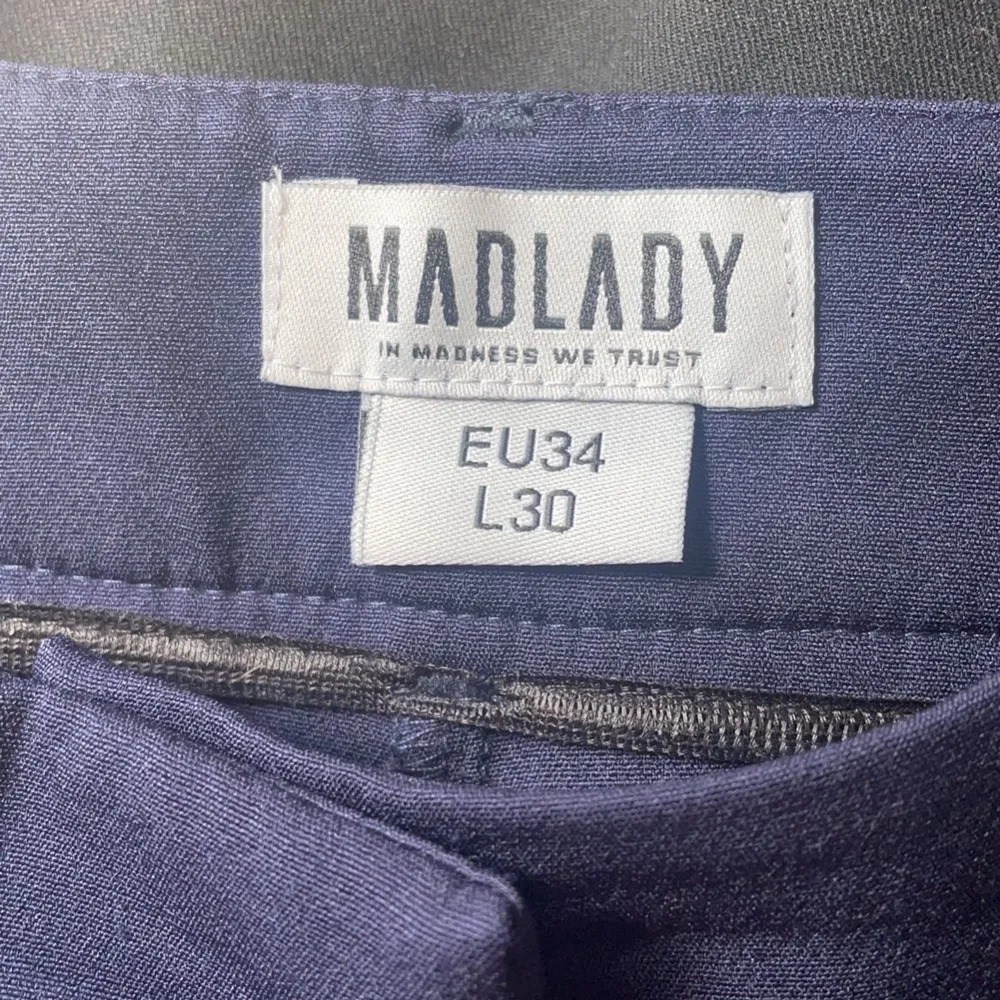 Ett par blåa kostymbyxor med pressveck ifrån Madlady, bra skick. Storlek EU 34 - L 30 (frakt på 50kr tillkommer). Jeans & Byxor.
