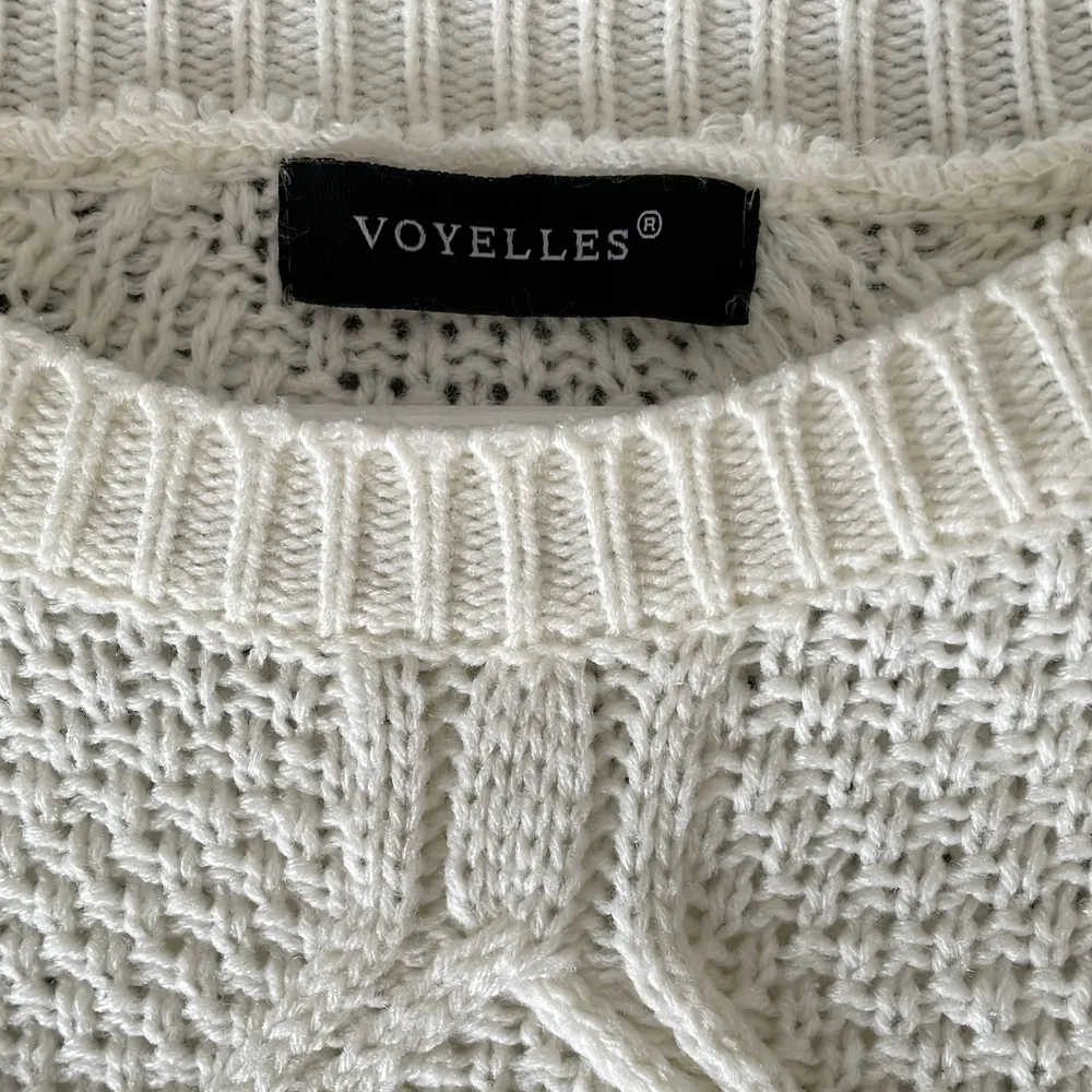 En mjuk vit stickad tröja, med lite mönster. XS, från Voyelles!🫶🏼💕 Har en liten ögla som gått upp men lätt att fixa!. Stickat.