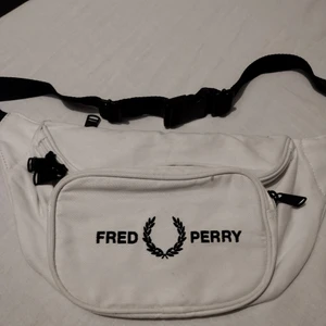 Fred Perry Mens Graphic Waist Bag - Fred Perry Mens Graphic Waist Bag . Embroidered branding. 100% polyester. Zip fastening main compartment and front pocket. Adjustable strap with clip. Size: 36x16x8cm approx.