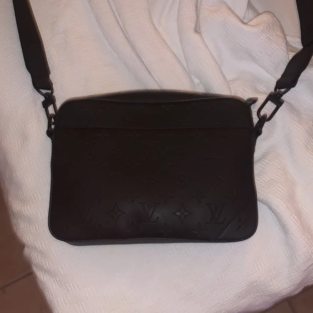 En svart Lui Vuitton Messenger bag. Den är i bra skick köpt för cirka 2 månader sen. En riktigt fin väska för män som matchar till allt eftersom den är svart . Accessoarer.
