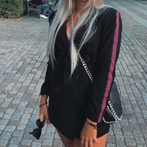 Playsuit/jumpsuit/byxdress  - Säljer denna Playsuit/jumpsuit/byxdress från chiquelle, storlek 38, finns en blå och röd rand på armen, finns inbyggda shorts