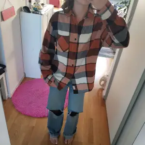 Oversized orange flannel. Its in very good condition, has buttons on the arms and barely used