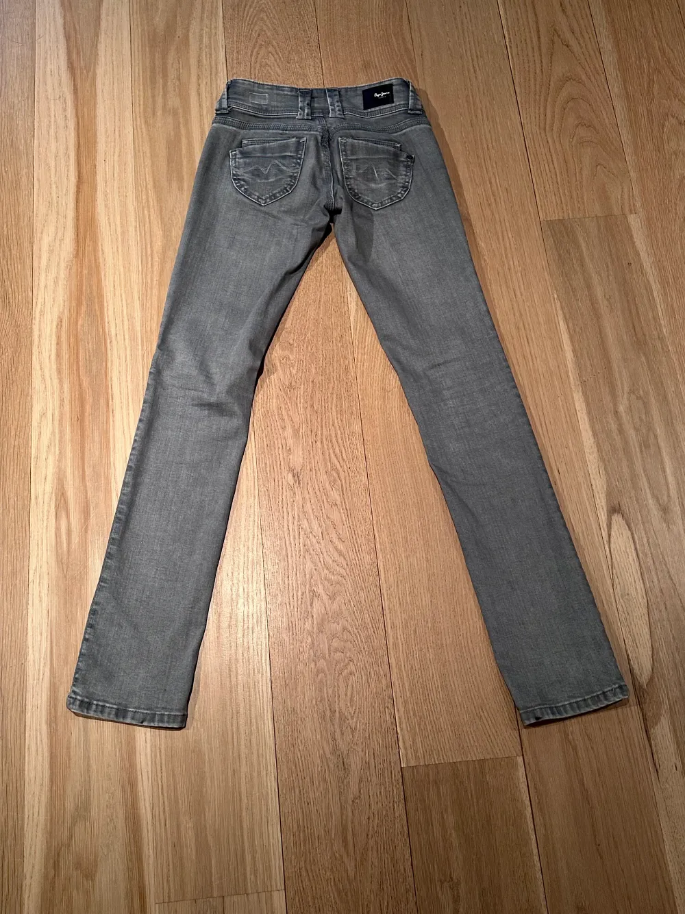 Jättefina lågmidjade ”Venus” raka jeans i färgen grå. Använda fåtal gånger. Säljer då de tyvärr inte kommer till användning längre. Strl: 25/34 Innebenslängd:83,5 cm midjemått (tvärs över):ca36 cm. Jeans & Byxor.