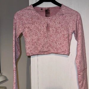 Gymshark Textured Fleur Long Sleeve Crop Top - Thick soft jacquard. Poly/nylon/elastane blend. Soft red, close to pink color with white. Print fully intact. No holes, tears, rips, stains, snags, fuzz, fading, runs, pilling. Smoke and pet free storage space. Will gladly take more pics.