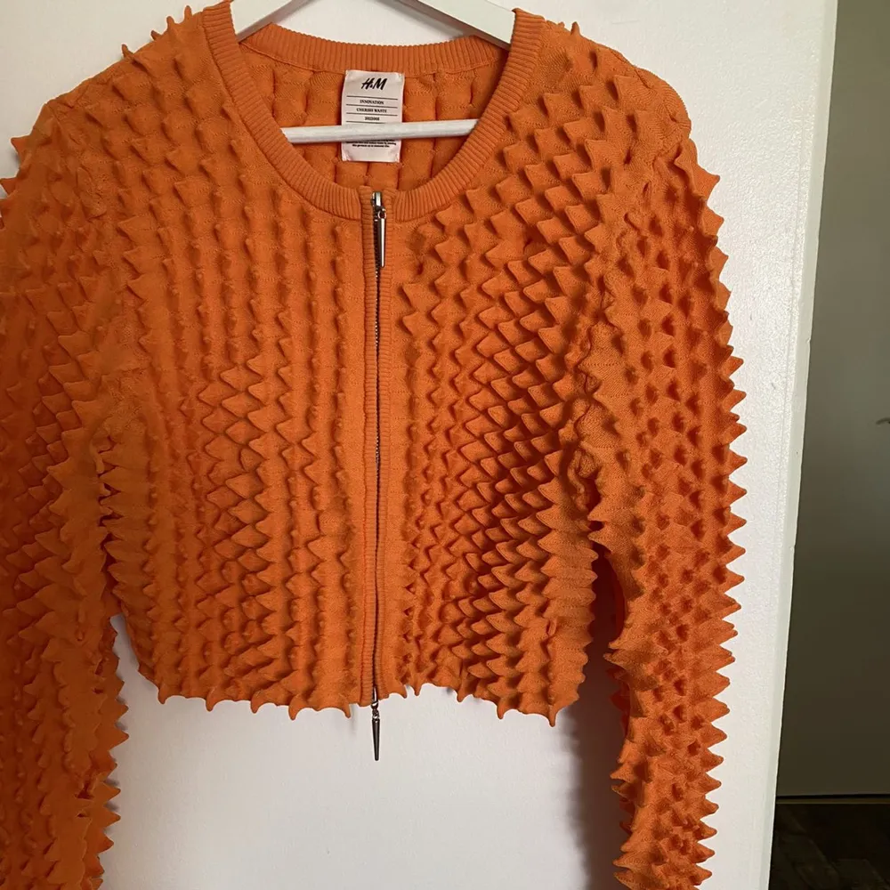 Orange croppad cardigan från HM collectionen the cherish Waste aldrig använd. Köptes för 999kr säljer den för endast 200kr . Tröjor & Koftor.