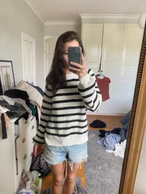 Randig stickad tröja ifrån Lindex - En svart vit randning tröja ifrån lindex, super fin nästan aldrig använd. Ser helt ny ut. Nypris 425kr.