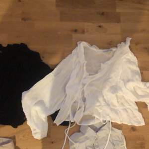 50kr each , blouses , there’s a white and black version of the same blouse that closes with ties in the front, Piet blouse style , one button up linen shirt and one linen vest shirt 
