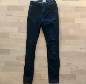 Jeans - Mörkblåa skinnyjeans med hög midja från Tommy Hilfinger. Använd 1-2 gånger. Storlek 26