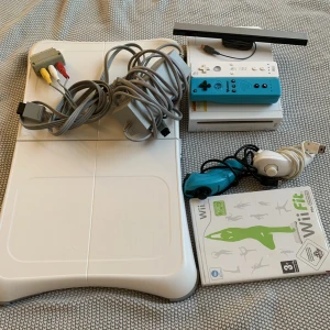 Nintendo wii & balansen board - Nintendo Wii med balansbräda och tillhörande spel. Den blå kontrollen är helt ny och oanvänd. Den vita kontrollen fungerar inte men följer med om man vill, utan extra kostnad, då ”nunchuck”kontrollen fungerar som den ska. Fraktar eller möts upp i malmö
