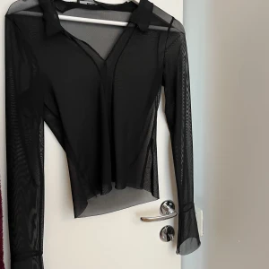 Mesh topp - Svart topp i Mesh. Aldrig använd. Har utsvängd vid händerna 