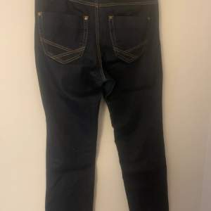 Ett par vintage jeans  Bootcut jeans med snygga detaljer på fickorna 