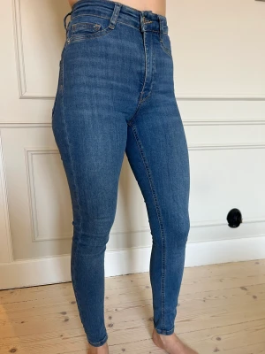 Blå jeans  - Blå tajtare jeans. Lite stretch i tyget. 