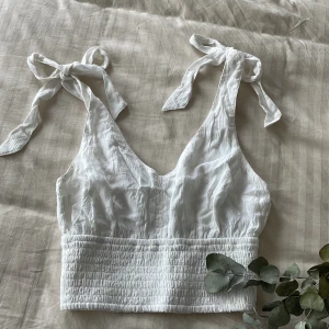 Vit topp i XS - Vacker topp i XS från Hollister. Endast använt 2-3 gånger. Vit och fräsch, använder den inte längre så säljer den till nån annan som vill bära den 🥰 