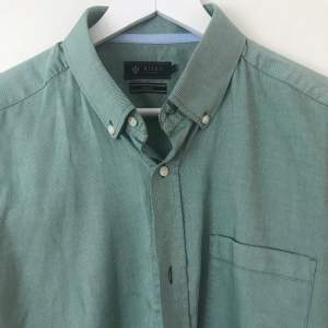 Säljer en Slim fit skjorta från Brothers. En fin grön färg och den är i mycket bra skick. Använd den ett fåtal gånger. har väldigt många skjortor fråga  gärna så skickar jag bilder på liknande plagg.  Köparen står för frakten 