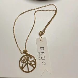Smycke från Deuc Sweden - Fint Smycke i guld ”Unity” från Deuc Sweden.  Aldrig använd.  Längd på kedjan är 43,5 cm. 