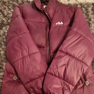 Fila jacka  - En jättefin lila puffer FILA Jacka, jackan är i bra sick, har 2 fickor på utsidan och en på insidan, är väldigt bekväm och varm på vintern🧊⚡️🫶 pris kan diskuteras💗