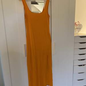 Orange långklänning med slit 