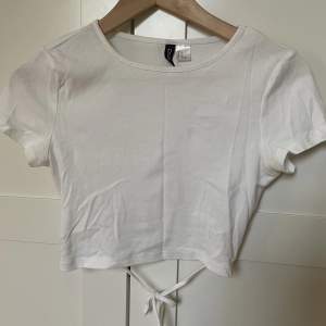 Säljer denna snygga vita t-shirten med knytning i ryggen💗endast använd en gång 