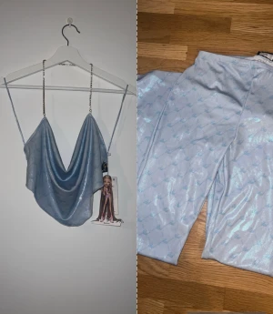 Sett Bershka x Bad gyal - Helt nytt sett från bershka från deras Bad gyal kollektion, ett extremt snyggt ljusblått glansigt sett med texten Bad på tyget och guld/kristall detaljer i Storlek M,inte ens testat prislapp finns kvar på plagget, byxorna har även utsvängda ben längst ned