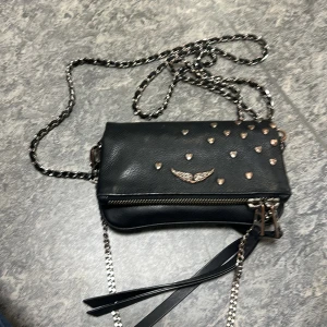 Zadig rock nano heart clutch - Säljer min jätte fina Zadig limited edition väska i lilla modellen. Relativt bra skick men lite rostig, kommer med äkthetsbevis. Pris kan diskuteras och kan även tänka mig att byta till tex en maje väska i svart (skriv för bilder)