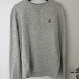 Grå Lyle & Scott sweatshirt - Grå Lyle & Scott tröja i mycket fint skick. Herrmodell i storlek M