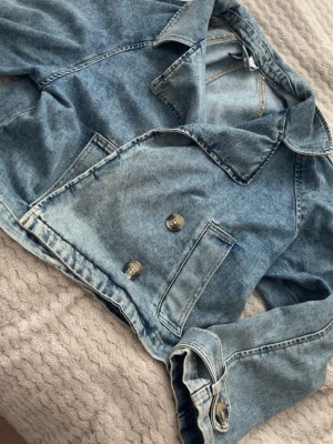 Ljusblå cropped jeansjacka - Säljer en ljusblå cropped jeansjacka från H&M. Använd en gång 