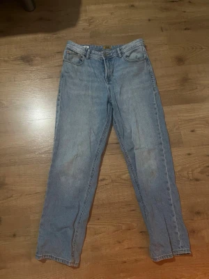 Ljusblå raka jeans i klassisk modell - Ljusblå jeans med rak passform och hög midja. Klassisk femficksdesign och gylf med dragkedja. Jeansen har en enkel, tidlös look och är tillverkade i denim. Perfekta för en avslappnad stil. Det är stolek 164 i kille (14Y) 