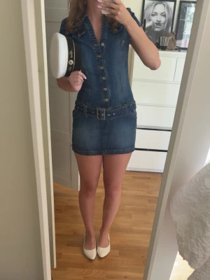 Jeansklänning  - Snygg jeansklänning från bershka! Har ett hål vid sidan precis över slitsen men det syns inte mycket och går att sy igen lätt!