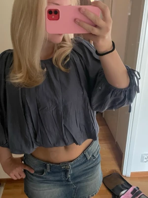Mörkblå croppad blus från hm ! - Säljer en mörkblå croppad blus med vida trekvartsärmar och knyt i ärmsluten. Från hm väldigt populär 💓