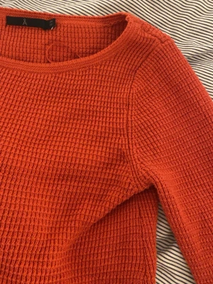 Röd stickad tröja med struktur - Säljer en corall röd/ orange stickad långärmad tröja. Säljer den främst för att den inte kommit till någon användning alls. Köpte den sekond hand.  Den är inte nopprig och ser ingen slitning på den, inte heller några fläckar. Om ni är intresserade är det bara att skriva till mig