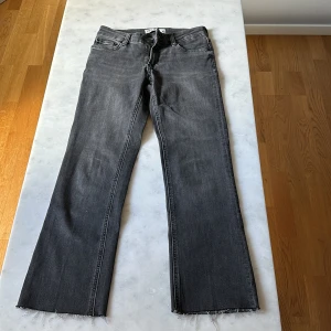 Gråa jeans från Zara - Snygga gråa lågmidjade mid flare jeans från Zara. 