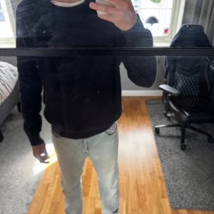 Svart stickad tröja från Zara - Säljer en mörkgrå stickad tröja från Zara i storlek L. Tröjan har en rund hals och ribbade muddar vid ärmslut och nederkant. Perfekt för dig som gillar enkel och stilren look. 