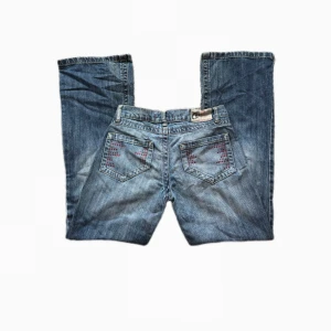 Jeans - Sjukt snygga lowaist bootcut strom jeans <3 röda snygga detaljer på fickorna. Midjemått: 36,5cm innerbenslängd: 75cm 🪽