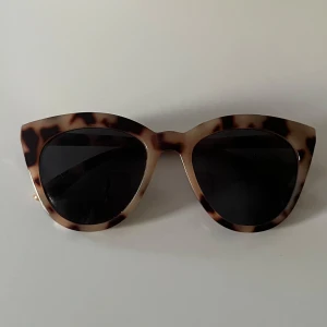 Leopardmönstrade cat eye solglasögon - Solglasögon i cat eye-modell med leopardmönstrad båge i beige och bruna toner