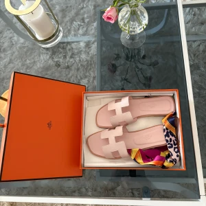 Hermes oral light pink - Hermes tofflor i perfekt skick. Stilrena och passar perfekt för sommaren, eller andra event. Box och påse ingår.