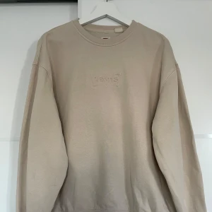 Levis tröja - Sweatshirt från Levis i en beige färg med utstickande märke.