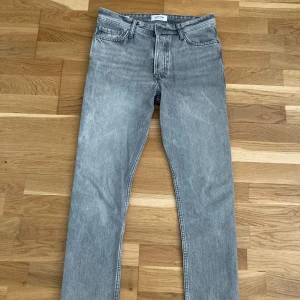 Jack & Jones jeans gråa - Gråa Jack & Jones jeans som knappt har blivit använda. Utmärkt skick och endast lite solblekta. Perfekt för alla årstider.