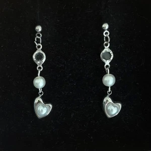 Silverfärgade örhängen med pärlor och hjärtan - Handgjorda och unika silverörhängen  🤩 Hela örhänget är i 100% rostfritt stål (ej silverpläterat) 💕🙏4 cm långa. Alla köp görs via ”KÖP NU” knappen.  💐