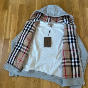 Grå Burberry hoodie - Grå burberry hoodie storlek M men passar S lite kort i storleken. Men passar folk som har S