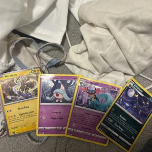 Pokémonkort - Samling med fyra coola Pokémonkort: Miraidon, Hatenna, Dragapult och Umbreon. Perfekt för dig som vill boosta din samling eller spela med vänner! Korten har snygga illustrationer och är i fint ny skick – ett måste för alla Pokémonfans.