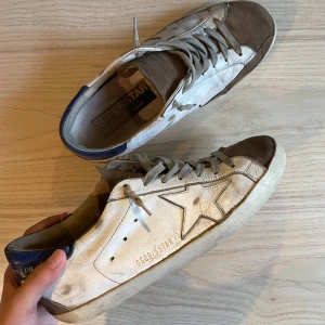 ! Ett par golden goose super star - Hej, jag säljer mina golden goose i strl 41-42 som har tecken på användning som till exempel hål i hälen och det är därför priset är som det ska, men det är inget men tänker på när man har på sig dom! Skick 6/10! 