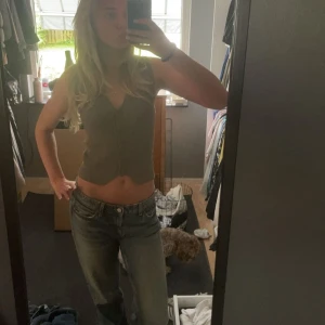 Grå ribbad väst  - Säljer en snygg grå ribbad väst med v-ringning. Toppen är ärmlös och croppad, perfekt för varmare dagar. Den är från Zara och är i väldigt bra kvalité då jag använt den mycket men har inga skador. 