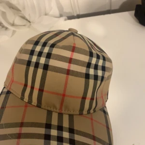Burberry keps  - Knappt använd burberry keps. Storlek L men passar alla huven. Den är som ny helt fräsch inga fel med den.