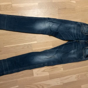 Blå jeans från Replay - Snygga blå jeans från Replay i modellen Anbass. De har en klassisk femficksdesign och en lätt tvättad look som ger en cool stil. Perfekta för en avslappnad vardagslook.