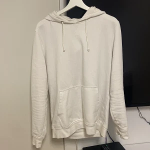 Vit hoodie från Pier One - Säljer en stilren vit hoodie från Pier One. Den har en klassisk design med dragsko i huvan och en stor ficka framtill. Perfekt för en avslappnad look.