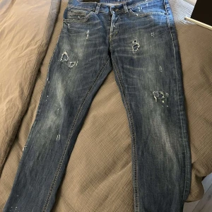 Dondup jeans - Säljer ett par extremt eftertraktade Dondup George jeans i storlek 33. Dessa jeans är speciella med sina unika slitningar och färg – du hittar inte ett par likadana någonstans‼️ Jag har inte sett någon annan sälja just dessa på marknaden. Mått har ni på sista bilderna!   Jeansen är i nyskick, endast använda 2-3 gånger. Nypris ligger på 3899 kr. Är öppen för prisförslag! Samt fler bilder👏