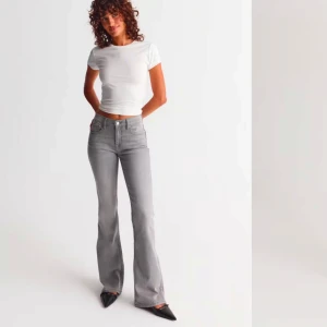 Grå bootcut jeans från Gina tricot  - Säljer ett par gråa bootcut jeans från Gina.